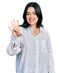 Beautiful hispanic woman wearing casual white shirt showing and pointing up with fingers number four while smiling confident and happy.