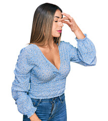 Young hispanic woman wearing casual clothes tired rubbing nose and eyes feeling fatigue and headache. stress and frustration concept.