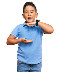 Little boy hispanic kid wearing casual clothes gesturing with hands showing big and large size sign, measure symbol. smiling looking at the camera. measuring concept.