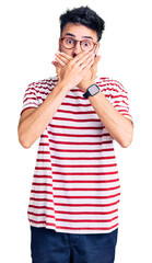 Young hispanic man wearing casual clothes shocked covering mouth with hands for mistake. secret concept.