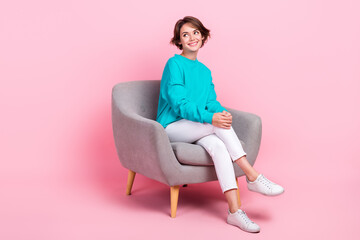 Full length photo of adorable gorgeous lady sitting cozy chair looking empty space seasonal offer...