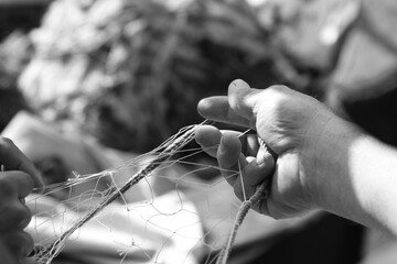 Fisherman's hands making fishing nets
