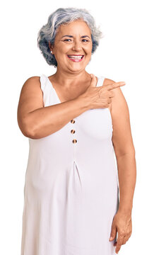 Senior woman with gray hair wearing casual clothes cheerful with a smile of face pointing with hand and finger up to the side with happy and natural expression on face