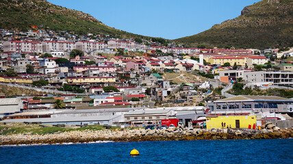 Local South African township housing residence area around Hout Bay hill side landscape from ocean