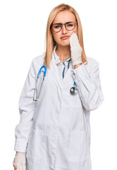 Beautiful caucasian woman wearing doctor uniform and stethoscope touching mouth with hand with painful expression because of toothache or dental illness on teeth. dentist