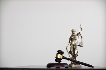 gavel wood and Brass court scales are used to decorate a table in a legal advisor office for...