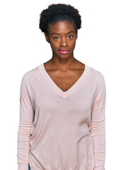 Young african american girl wearing casual clothes looking sleepy and tired, exhausted for fatigue and hangover, lazy eyes in the morning.