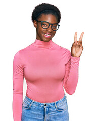 Young african american girl wearing casual clothes and glasses showing and pointing up with fingers number two while smiling confident and happy.