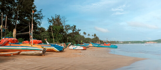 Fishing wooden boats by the ocean,Fishing boat in Sri Lanka,Fishing boats parked on the sand, fishing industry
