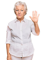 Senior grey-haired woman wearing casual clothes showing and pointing up with fingers number five while smiling confident and happy.