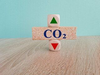 Blue text CO2 on brick block, cubes with arrow up down, concept of carbon reduction, Limiting...