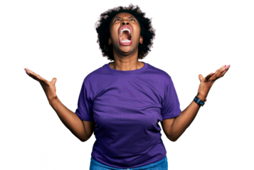 African american woman with afro hair wearing casual purple t shirt crazy and mad shouting and yelling with aggressive expression and arms raised. frustration concept.