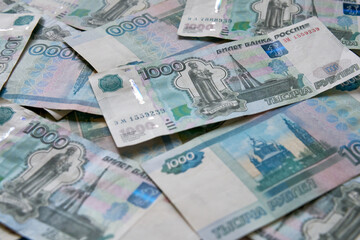 Fototapeta na wymiar A background of banknotes of 1000 rubles. Currency exchange rate.