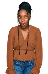 Young african american woman wearing casual clothes afraid and shocked with surprise expression, fear and excited face.