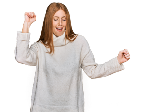 Young irish woman wearing casual winter sweater dancing happy and cheerful, smiling moving casual and confident listening to music