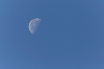 waning gibbous Moon in clear sky at day