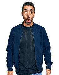 Young hispanic man wearing casual clothes afraid and shocked with surprise expression, fear and excited face.