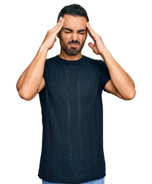 Young hispanic man wearing casual clothes suffering from headache desperate and stressed because pain and migraine. hands on head.