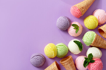 Pastel colored ice cream scoops and cones border on pastel violet background