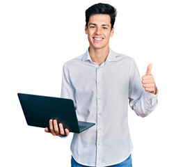 Young hispanic business man working using computer laptop smiling happy and positive, thumb up...