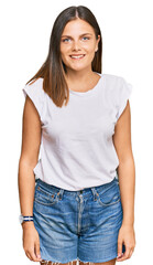Young caucasian woman wearing casual white tshirt with a happy and cool smile on face. lucky person.