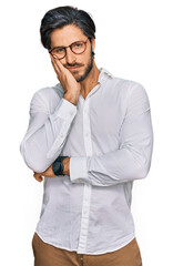 Young hispanic man wearing business shirt and glasses thinking looking tired and bored with depression problems with crossed arms.