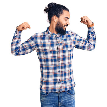 Young arab man wearing casual clothes showing arms muscles smiling proud. fitness concept.