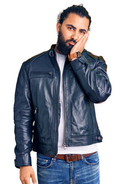 Young arab man wearing casual leather jacket thinking looking tired and bored with depression problems with crossed arms.