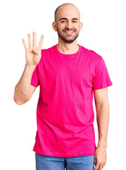 Fototapeta premium Young handsome man wearing casual t shirt showing and pointing up with fingers number four while smiling confident and happy.