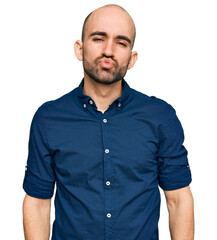 Fototapeta premium Young hispanic man wearing casual clothes looking at the camera blowing a kiss on air being lovely and sexy. love expression.