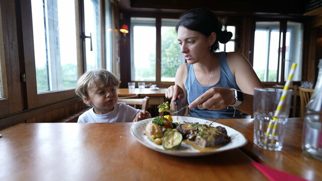 Mother And Child At Restaurant Mom And Kid Eating Food Meal