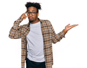Young african american man with beard wearing casual clothes and glasses confused and annoyed with open palm showing copy space and pointing finger to forehead. think about it.