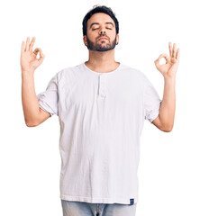 Young hispanic man wearing casual clothes relax and smiling with eyes closed doing meditation...