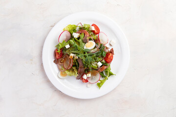 Salad with beef and tomatoes.