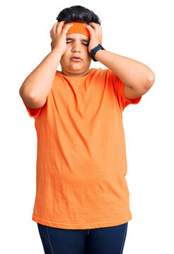 Little boy kid wearing sportswear suffering from headache desperate and stressed because pain and migraine. hands on head.