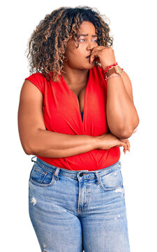 Young african american plus size woman wearing casual style with sleeveless shirt looking stressed and nervous with hands on mouth biting nails. anxiety problem.