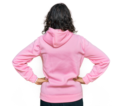 Young hispanic woman wearing casual sweatshirt standing backwards looking away with arms on body