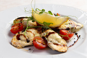 Cooked mussels with cheese in a plate.