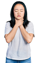 Young chinese woman wearing casual white t shirt shouting and suffocate because painful strangle. health problem. asphyxiate and suicide concept.