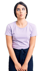 Brunette teenager girl wearing casual clothes making fish face with lips, crazy and comical gesture. funny expression.