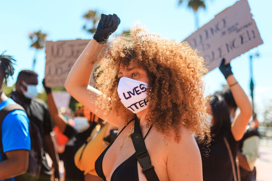 Woman protesting in mask with black lives matter inscription