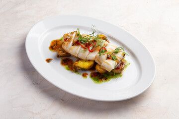 Fried squid and potatoes in a plate.
