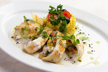 Stuffed squid in a bowl. On a light background.