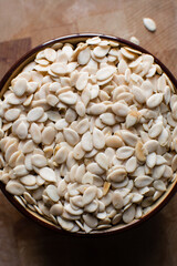 nigerian egusi seeds in a brown bowl, shelled melon seeds in a bowl, nigerian melon seeds, pumpkin seeds for cooking