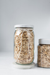 nigerian egusi seeds in a glass jar, shelled melon seeds in a transparent jar, nigerian melon seeds, pumpkin seeds for cooking