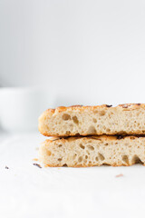 Cross section of focaccia on a white background, fresh homemade focaccia bread