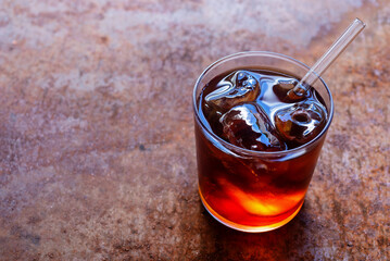 a glass of homemade cold brew coffee with iced on rusty table background.
