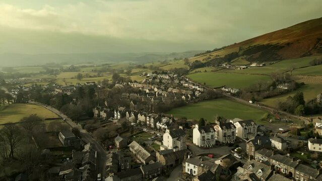 Behold the dramatic allure of the rural Cumbrian countryside through captivating drone footage, capturing the small English town of Sedbergh on the edge of the Yorkshire Dales
