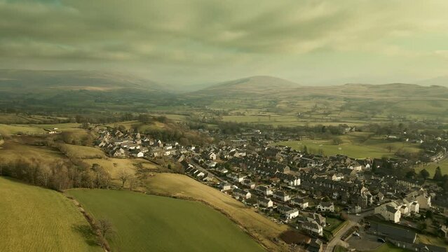 Behold the dramatic allure of the rural Cumbrian countryside through captivating drone footage, capturing the small English town of Sedbergh on the edge of the Yorkshire Dales