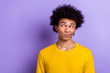 Photo of positive minded creative man look interested empty space contemplate isolated on violet...